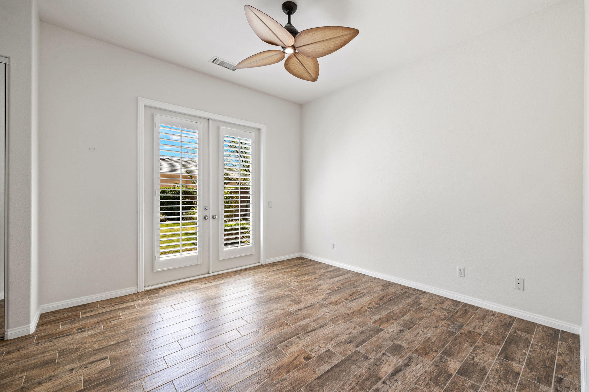 32 Calais Circle Rancho Mirage, CA 92270 - Photo 31 of 56 a view of empty room with wooden floor and fan