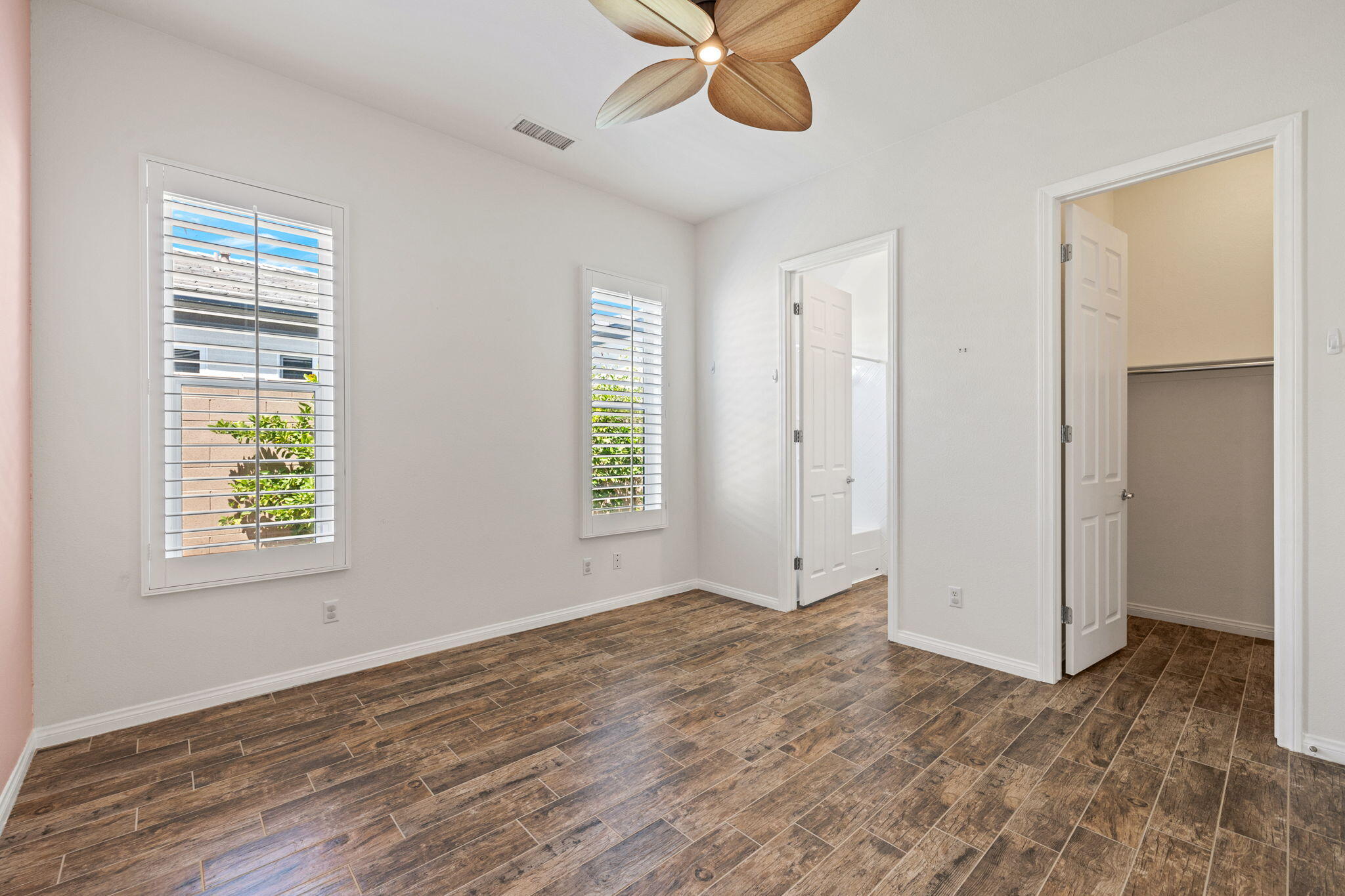 32 Calais Circle Rancho Mirage, CA 92270 - Photo 34 of 56 a view of an empty room with a window and wooden floor