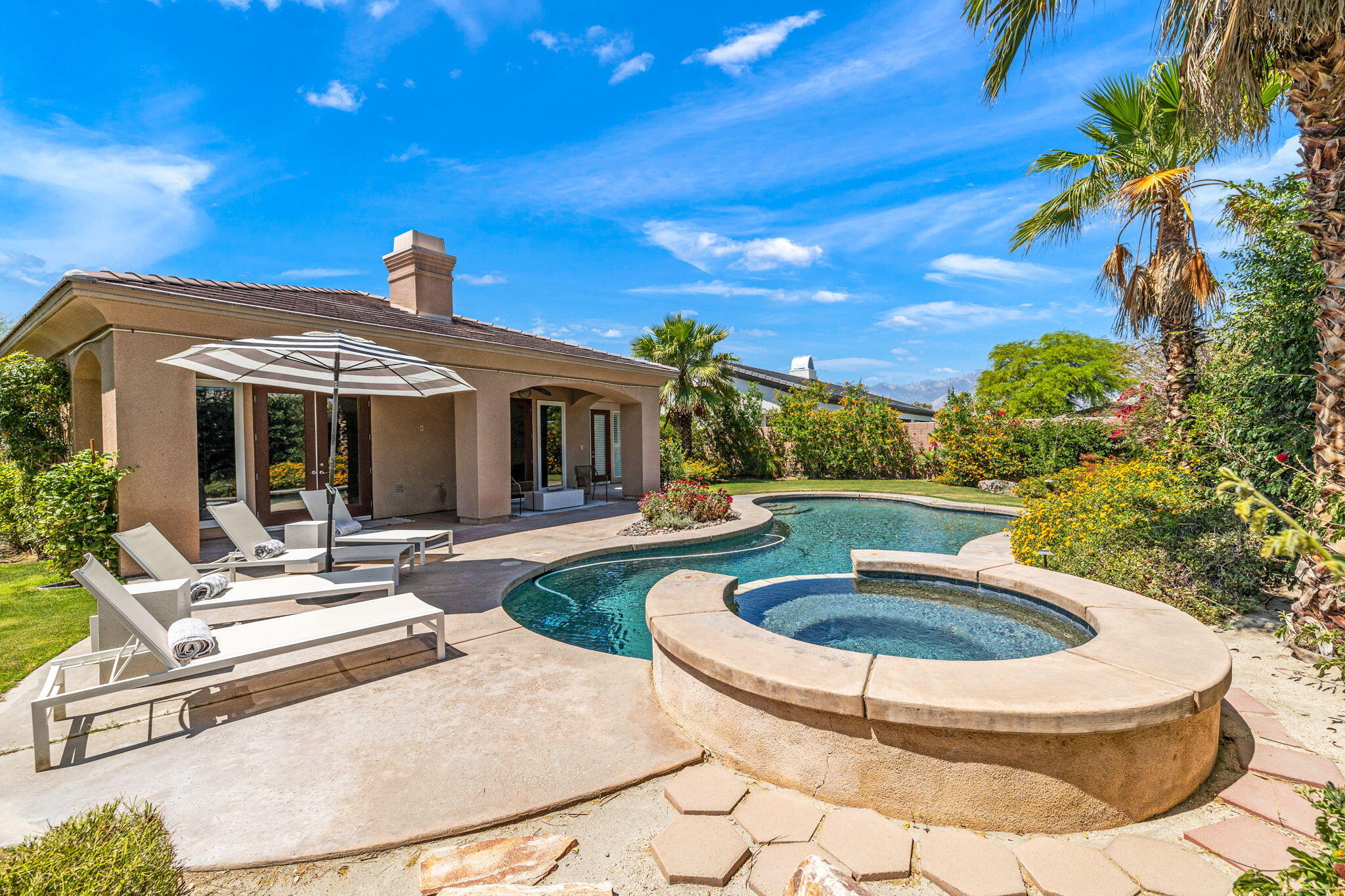 32 Calais Circle Rancho Mirage, CA 92270 - Photo 43 of 56 a view of a house with swimming pool and a yard