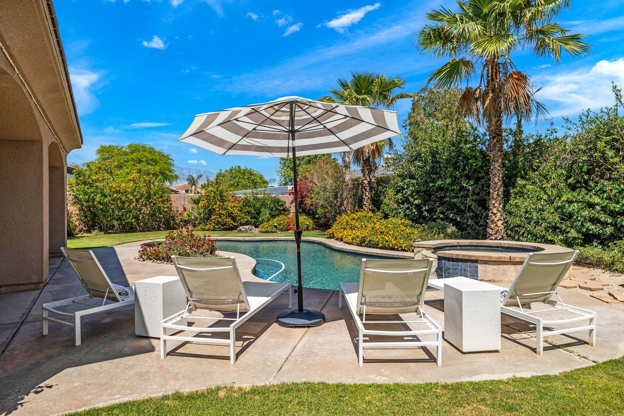 32 Calais Circle Rancho Mirage, CA 92270 - Photo 49 of 56 a patio with a table and chairs under an umbrella