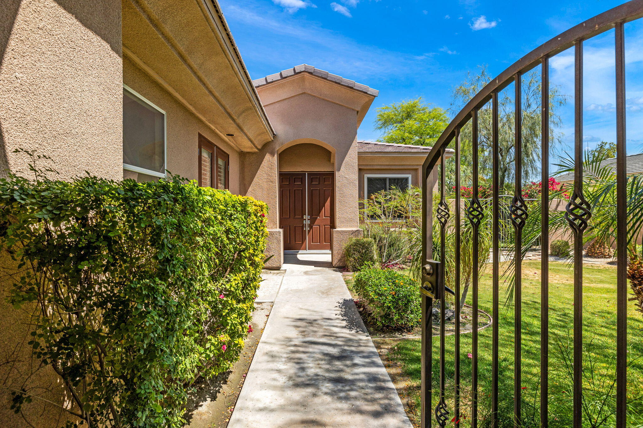 32 Calais Circle Rancho Mirage, CA 92270 - Photo 5 of 56 a front view of a house with a yard