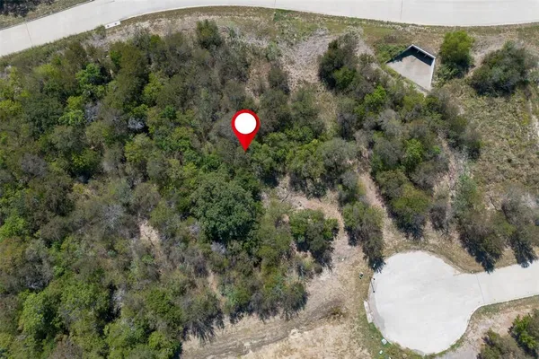 an aerial view of a house with a yard and lake view