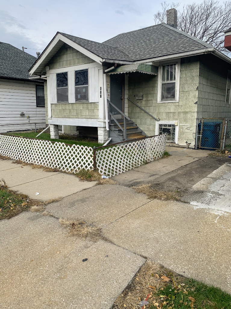 104 Pulaski Road Calumet City, IL 60409 - Photo 2 of 21 a front view of a house with a yard and garage