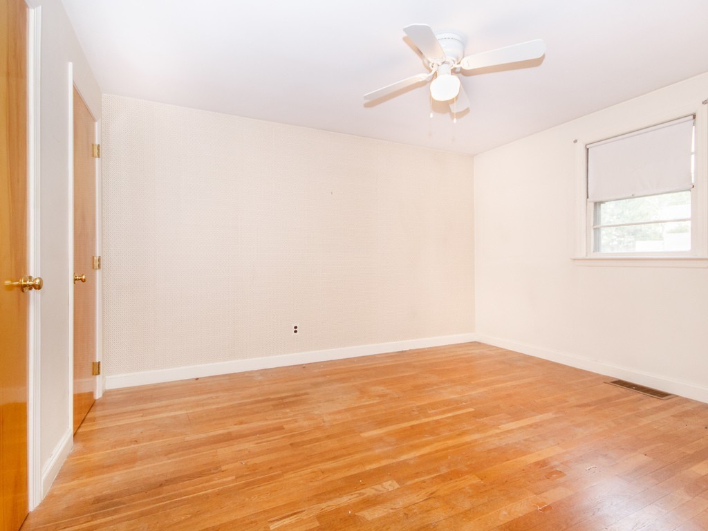 3 Trickett Road Lynnfield, MA 01940 - Photo 8 of 24 an empty room with a window and a ceiling fan