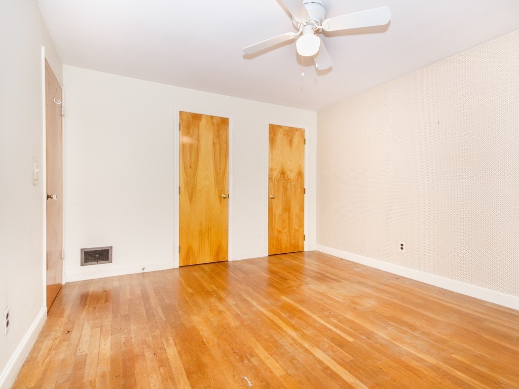 3 Trickett Road Lynnfield, MA 01940 - Photo 9 of 24 an empty room with wooden floor fan and windows