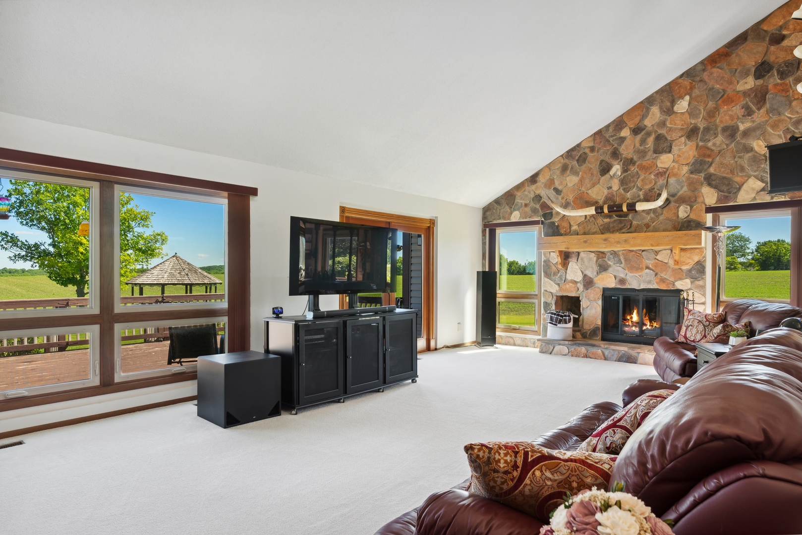 19720 Hebron Road Harvard, IL 60033 - Photo 17 of 41 a living room with furniture a fireplace and floor to ceiling windows