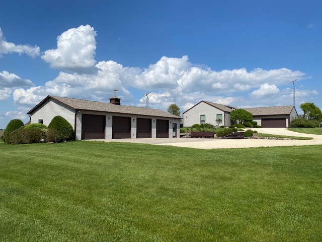 19720 Hebron Road Harvard, IL 60033 - Photo 31 of 41 a view of a house next to a big yard with plants and large trees