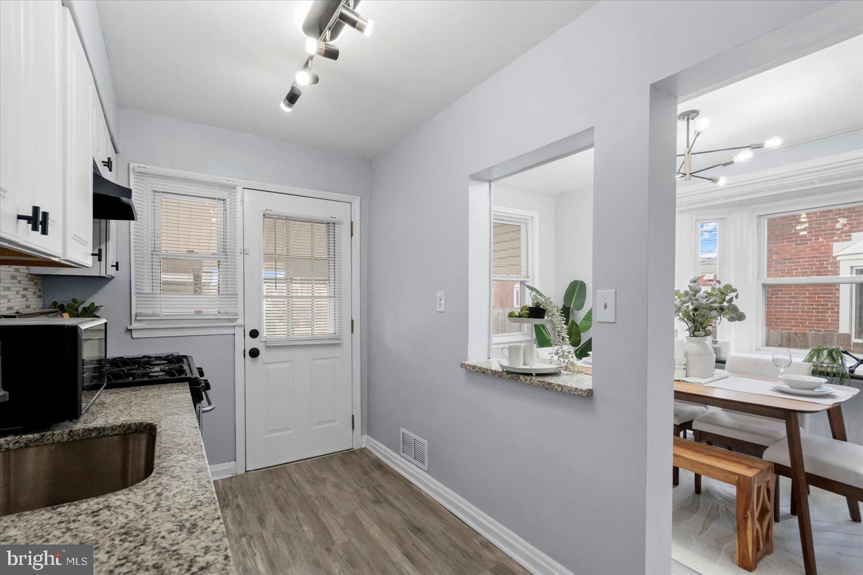 8411 Kavanagh Road Baltimore, MD 21222 - Photo 14 of 48 a kitchen with a refrigerator and a stove top oven