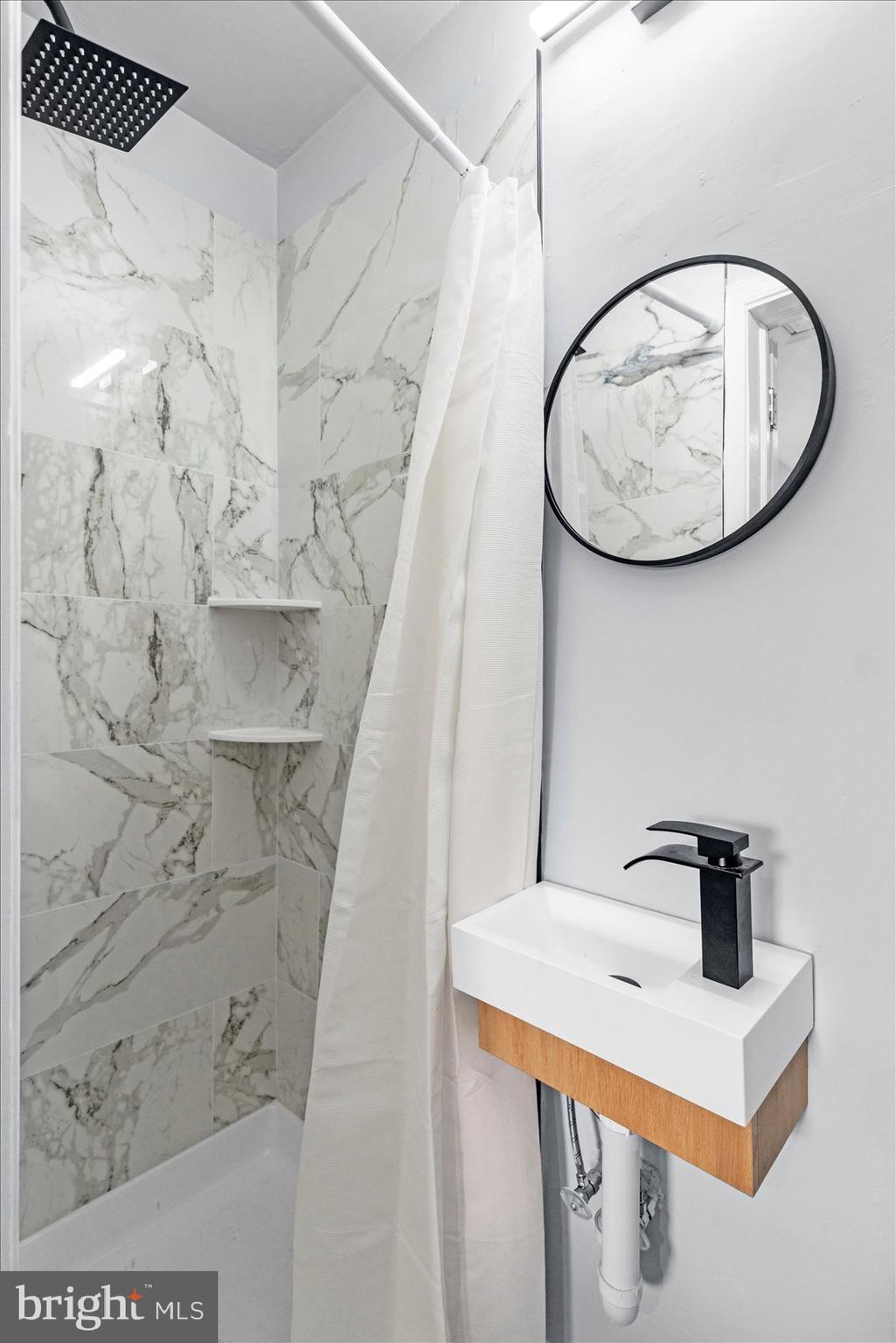 8411 Kavanagh Road Baltimore, MD 21222 - Photo 23 of 48 a bathroom with a sink and mirror