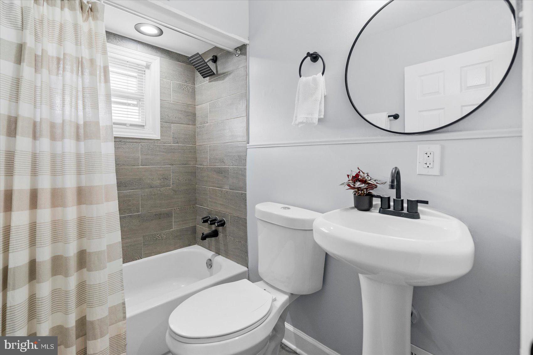 8411 Kavanagh Road Baltimore, MD 21222 - Photo 30 of 48 a white toilet sitting next to a bathroom sink