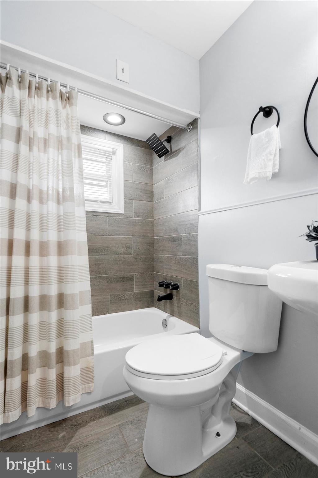 8411 Kavanagh Road Baltimore, MD 21222 - Photo 31 of 48 a bathroom with a toilet a sink and a shower