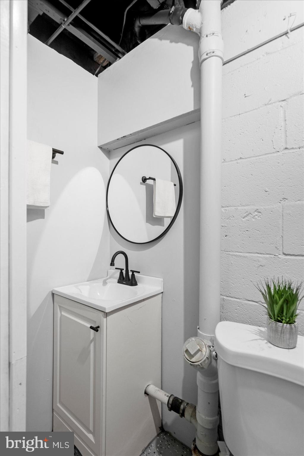 8411 Kavanagh Road Baltimore, MD 21222 - Photo 38 of 48 a bathroom with a sink toilet and a mirror
