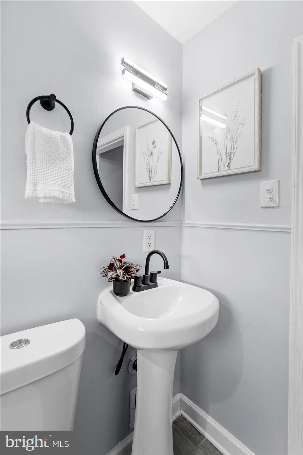 8411 Kavanagh Road Baltimore, MD 21222 - Photo 39 of 48 a bathroom with a toilet sink and mirror