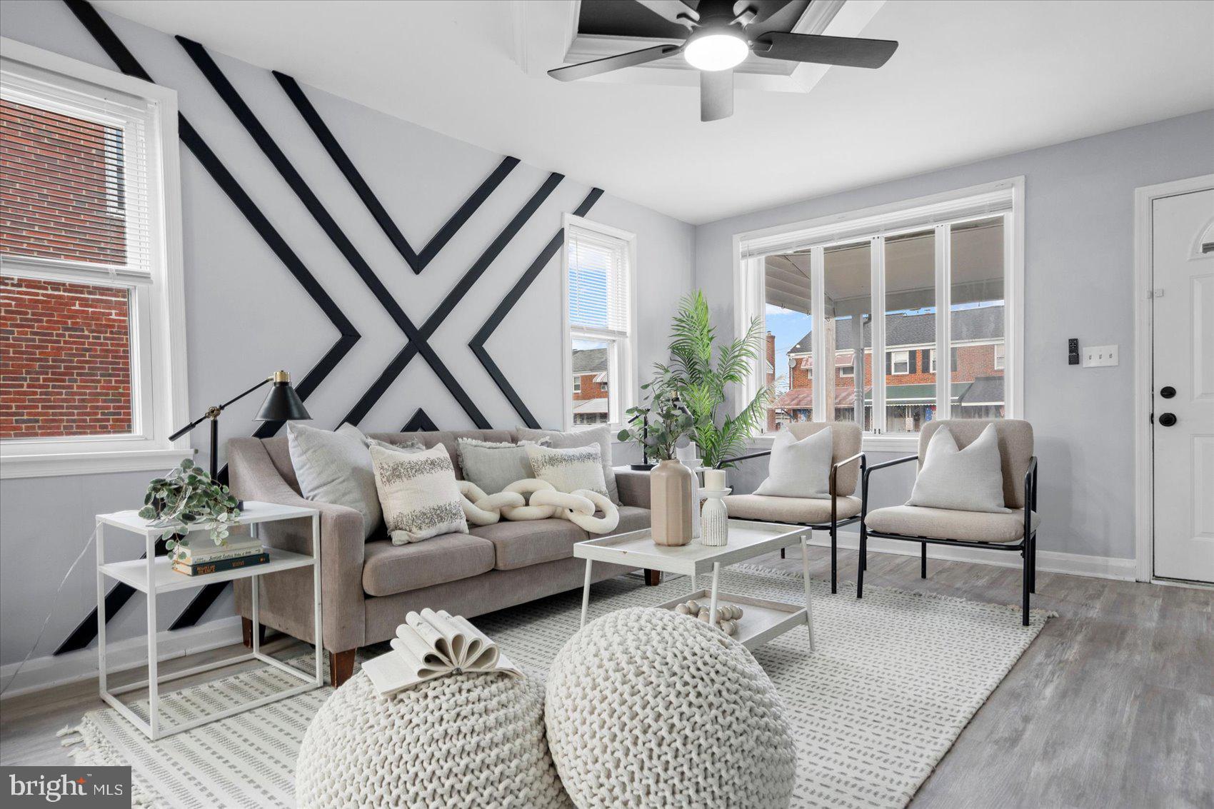 8411 Kavanagh Road Baltimore, MD 21222 - Photo 5 of 48 a living room with furniture a rug potted plant and a large window
