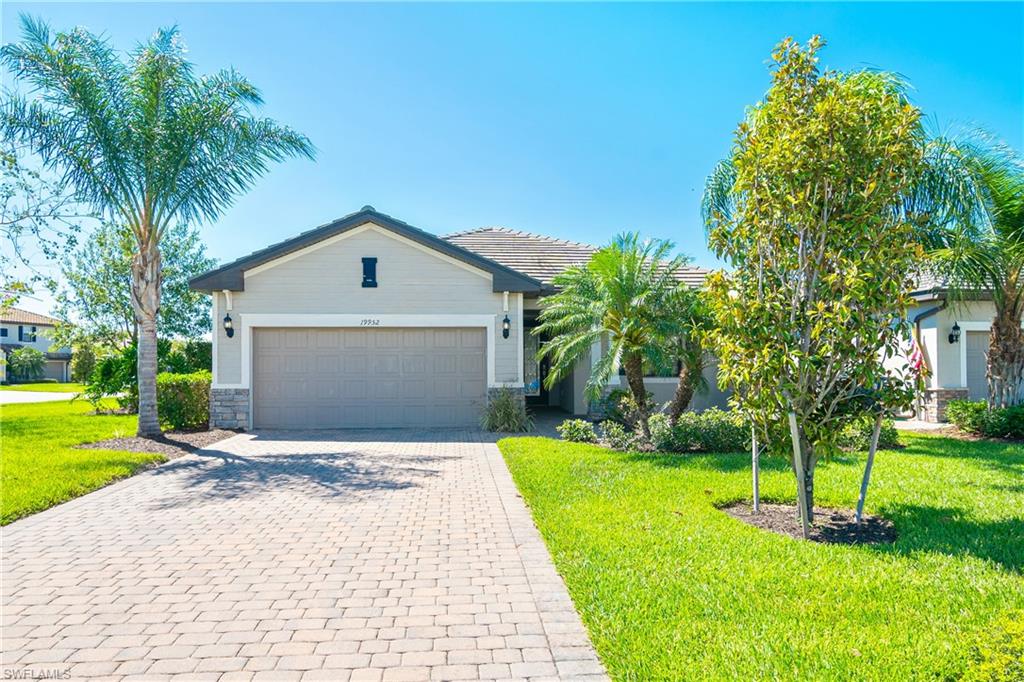 a front view of a house with a yard and garage