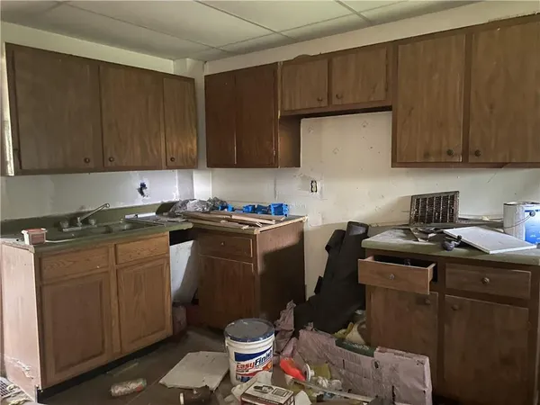 a kitchen with a sink a stove cabinets and black appliances
