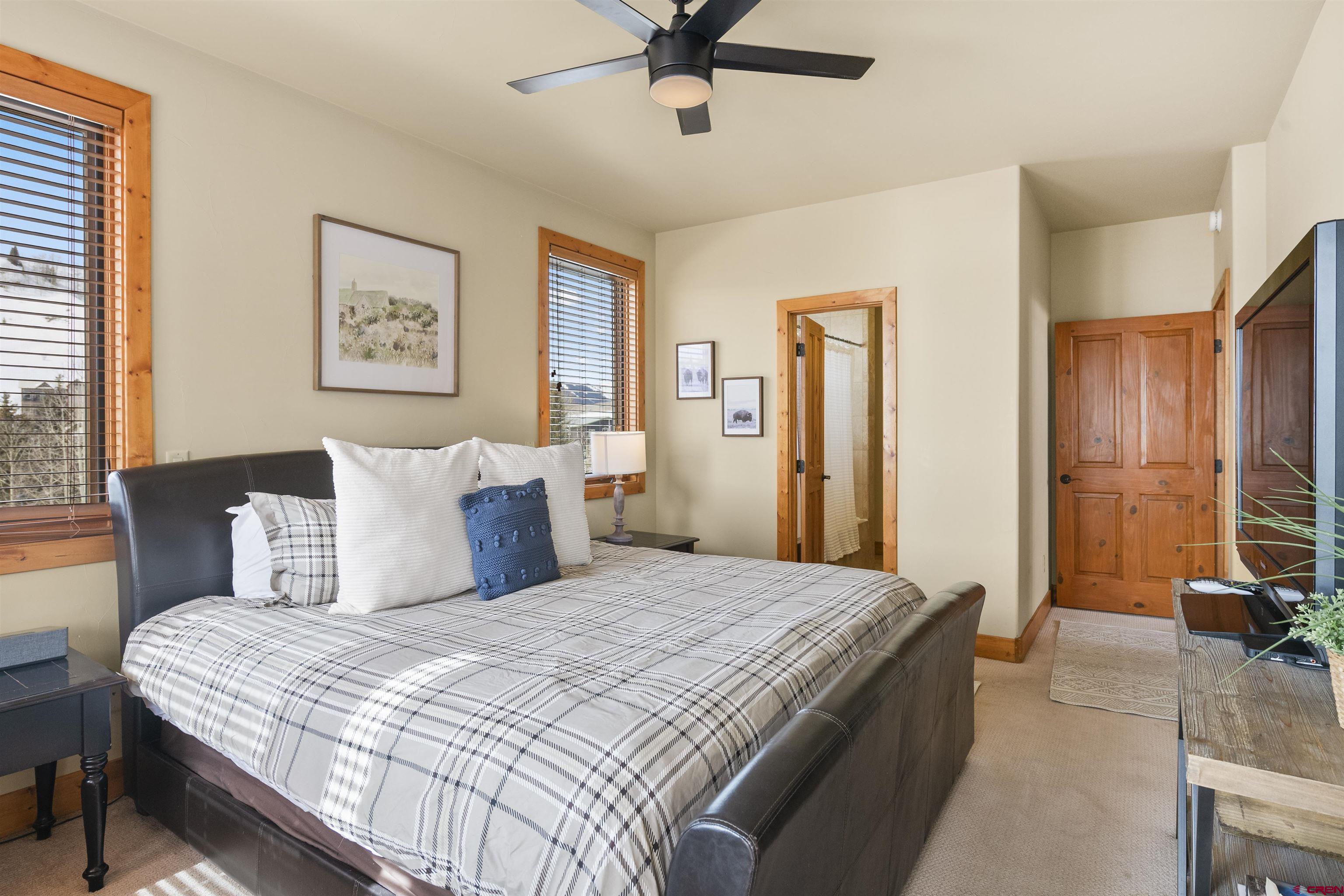 720 Gothic Road, Unit 3 Crested Butte, CO 81225 - Photo 12 of 29 a bedroom with a large bed and a chandelier