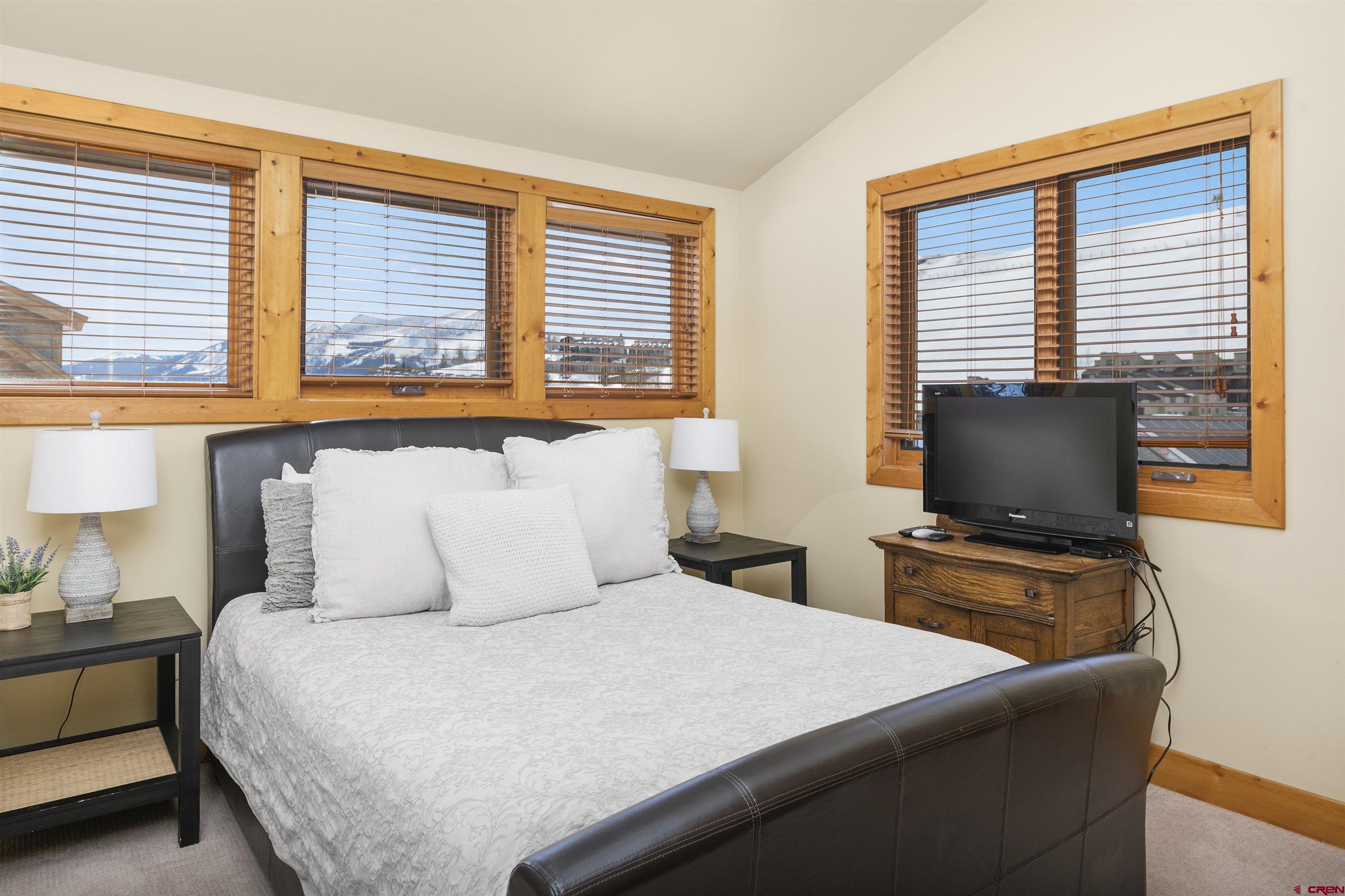 720 Gothic Road, Unit 3 Crested Butte, CO 81225 - Photo 13 of 29 a bedroom with a bed and a flat screen tv