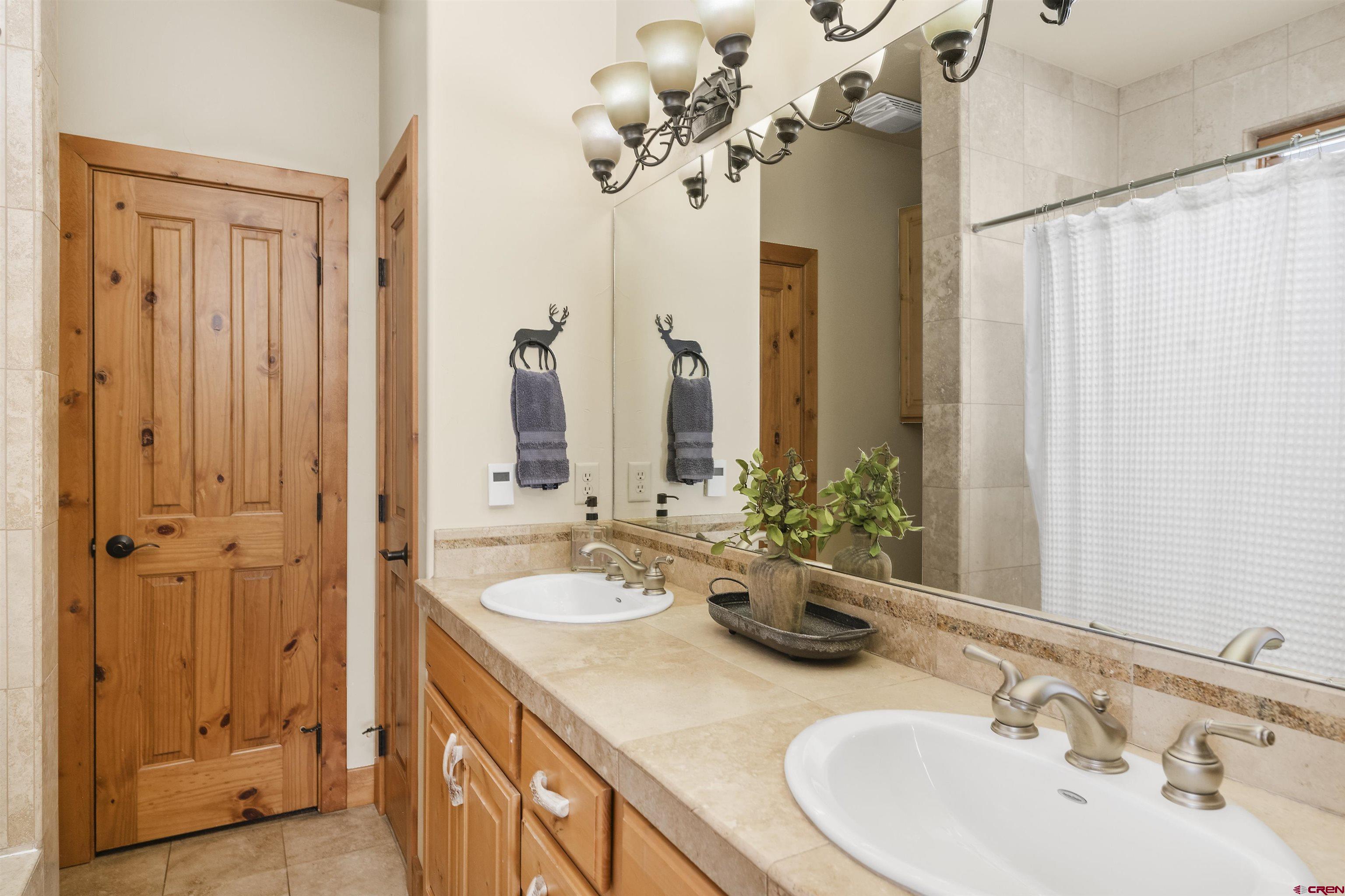 720 Gothic Road, Unit 3 Crested Butte, CO 81225 - Photo 17 of 29 a bathroom with a double vanity sink mirror and