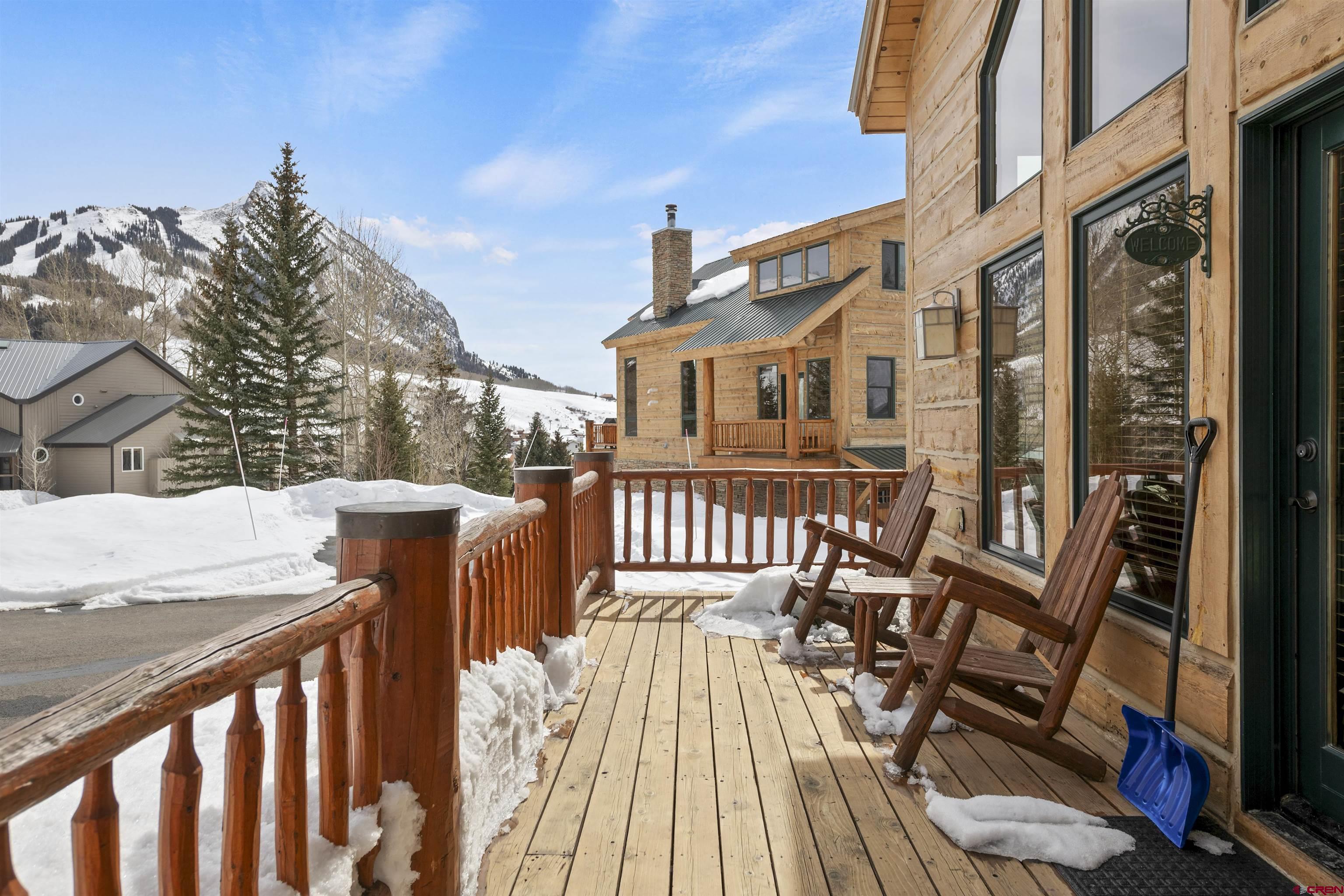 720 Gothic Road, Unit 3 Crested Butte, CO 81225 - Photo 21 of 29 a view of a brick house with wooden deck and furniture