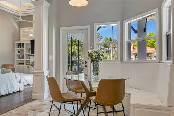 a dining room with furniture and a window