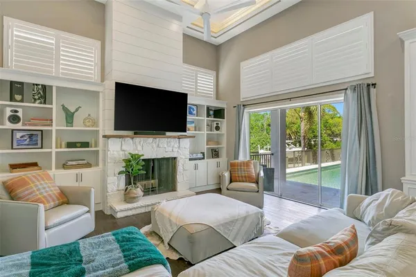 a living room with furniture a fireplace and a flat screen tv