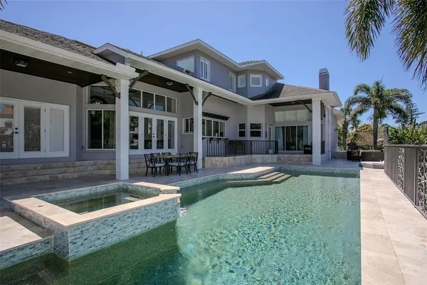 a view of a house with swimming pool and sitting area