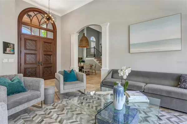a living room with furniture and wooden floor