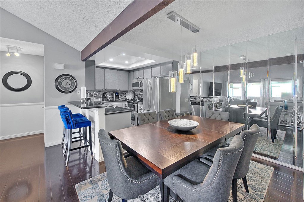 44 Carriage Way, Unit 108 Pomona, CA 91766 - Photo 12 of 44 a kitchen with a dining table and chairs