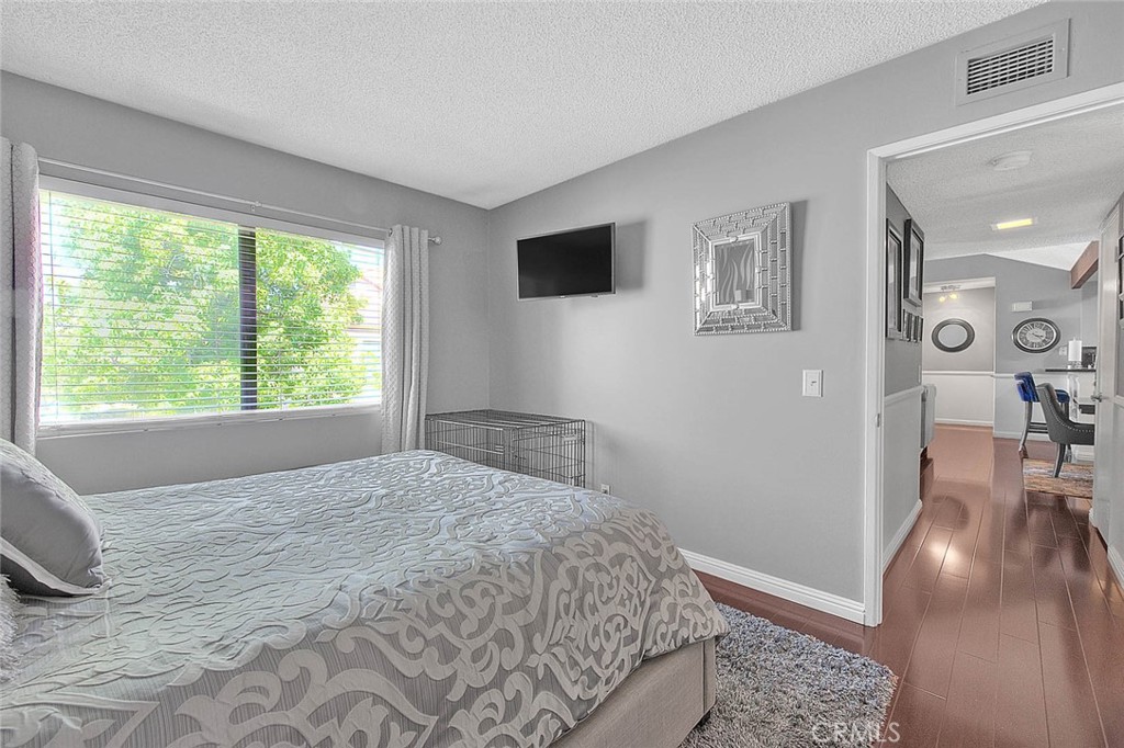 44 Carriage Way, Unit 108 Pomona, CA 91766 - Photo 26 of 44 a bedroom with a bed and a flat screen tv