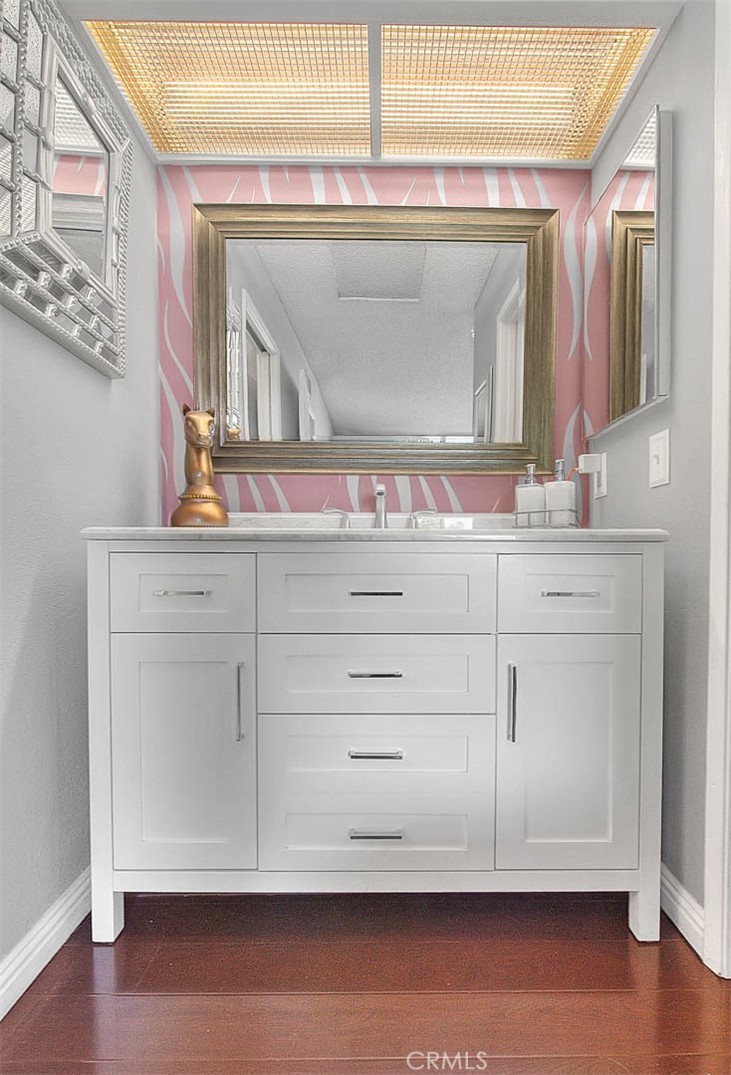 44 Carriage Way, Unit 108 Pomona, CA 91766 - Photo 28 of 44 a bathroom with a sink a mirror and a vanity with window