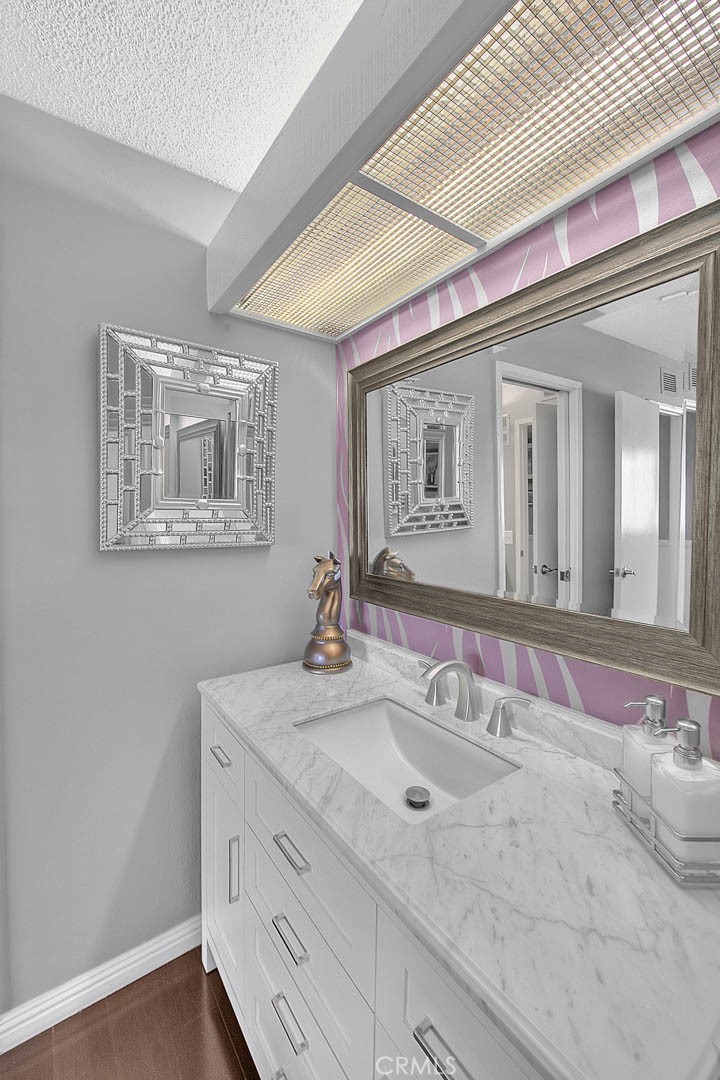 44 Carriage Way, Unit 108 Pomona, CA 91766 - Photo 29 of 44 a bathroom with a sink double vanity and a mirror