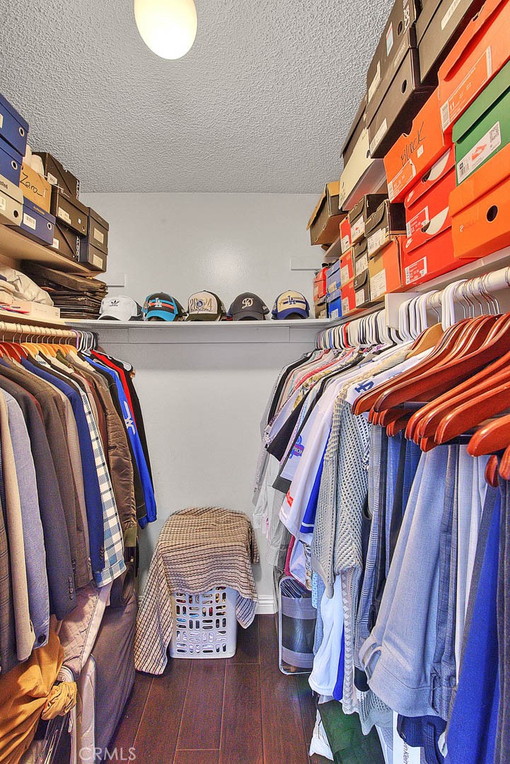 44 Carriage Way, Unit 108 Pomona, CA 91766 - Photo 31 of 44 a view of walk in closet with clothes and shoes