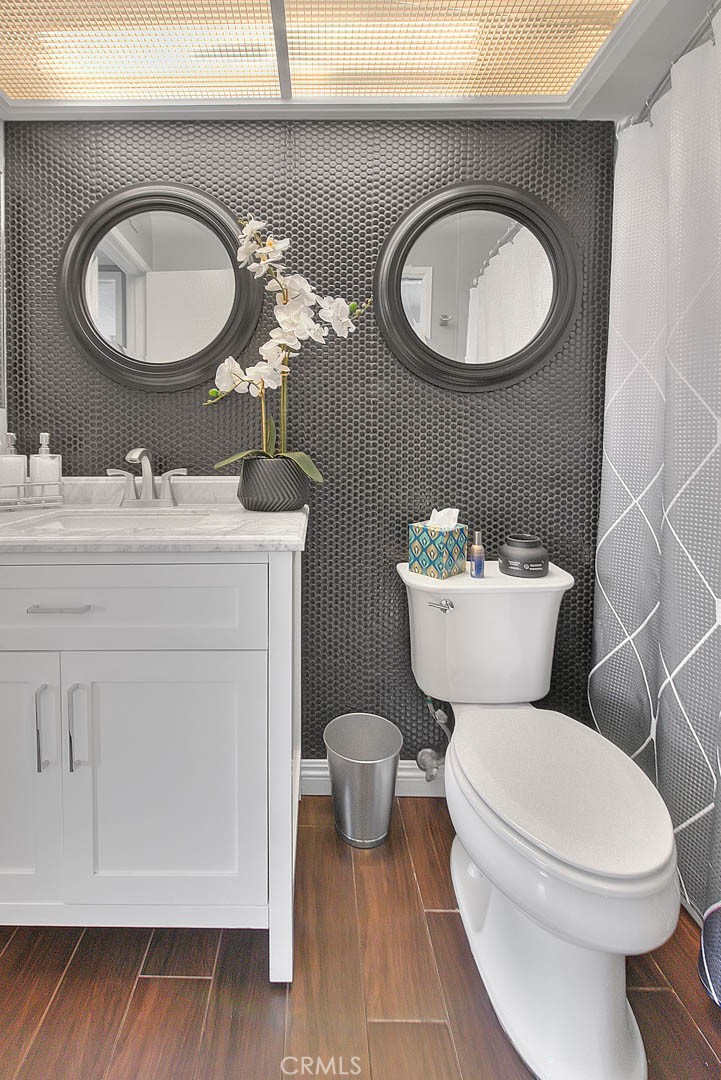 44 Carriage Way, Unit 108 Pomona, CA 91766 - Photo 36 of 44 a bathroom with a toilet a sink and mirror