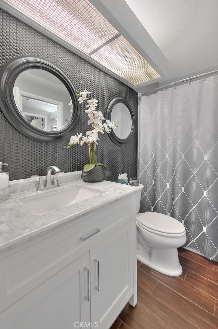 44 Carriage Way, Unit 108 Pomona, CA 91766 - Photo 37 of 44 a bathroom with a toilet a sink and a mirror