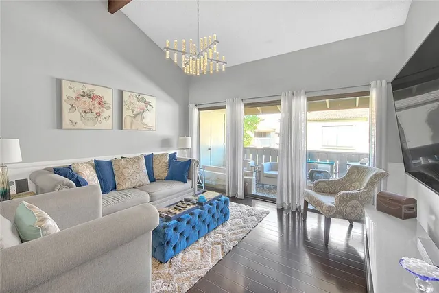 a living room with furniture a flat screen tv and a large window