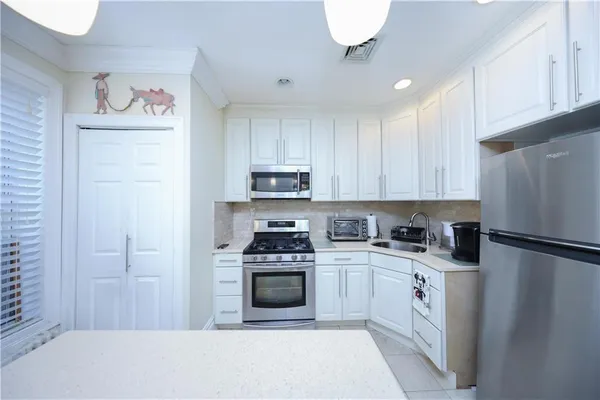 a kitchen with cabinets and stainless steel appliances