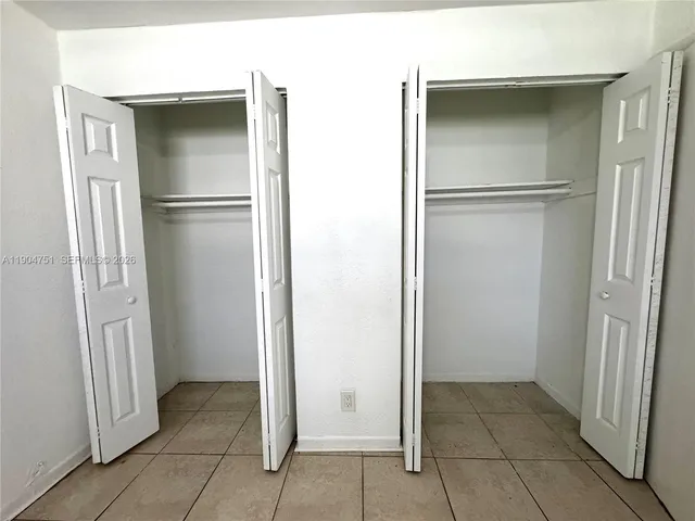 a view of storage and utility room with a refrigerator