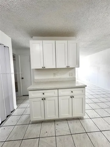 a kitchen with cabinets and a stove top oven