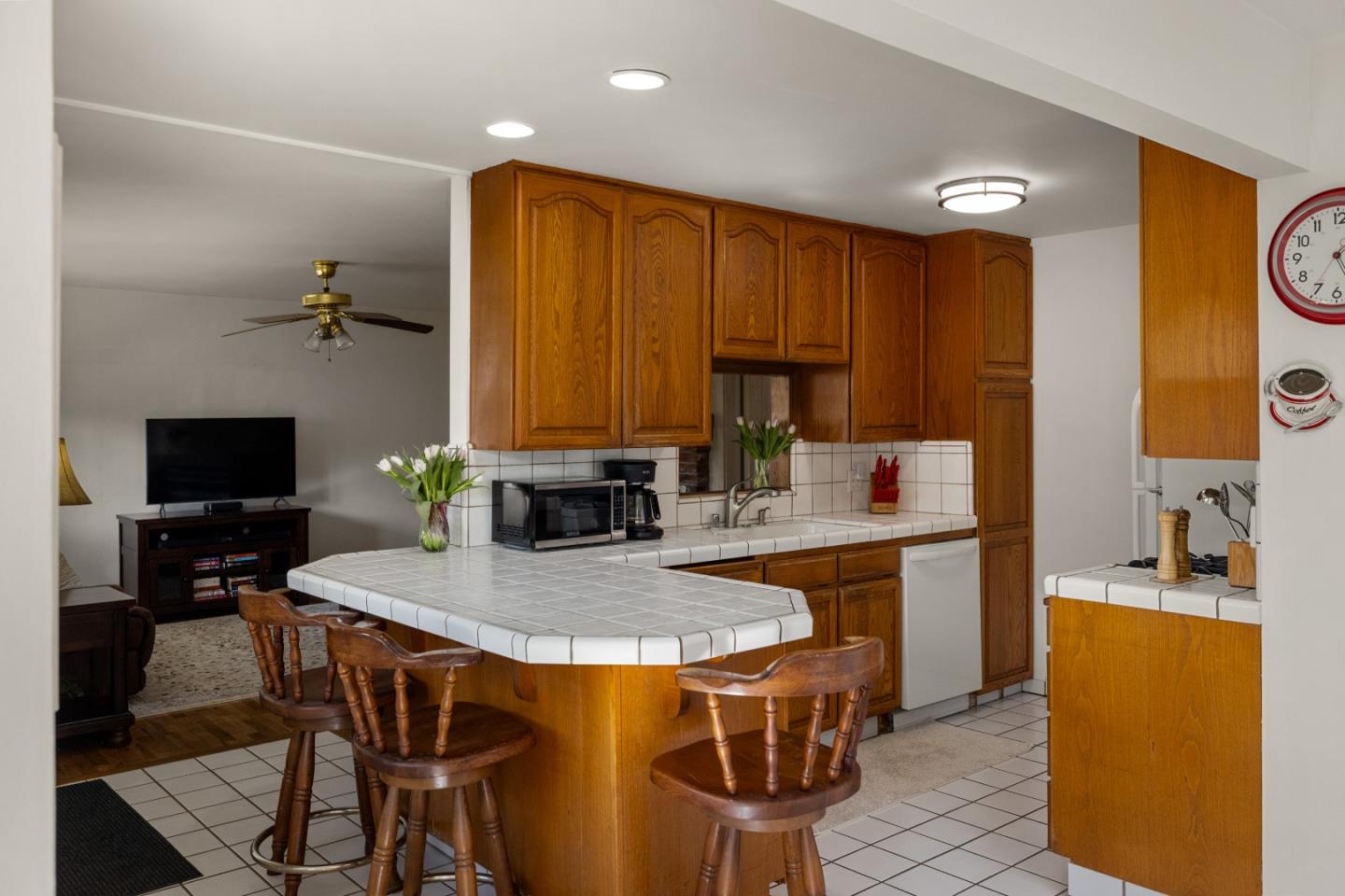 748 Alice Street Monterey, CA 93940 - Photo 12 of 36 a kitchen with a table chairs refrigerator and microwave