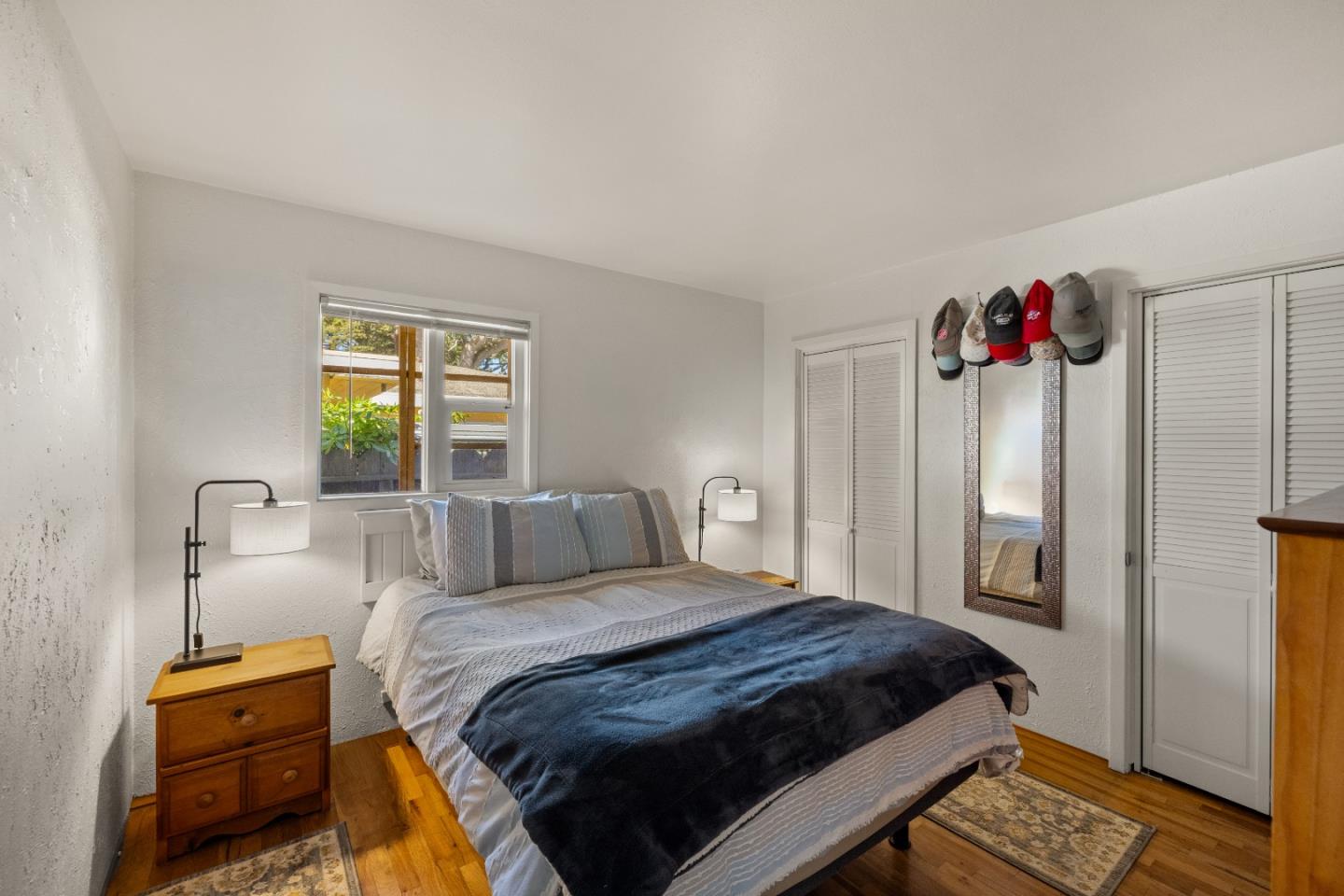 748 Alice Street Monterey, CA 93940 - Photo 18 of 36 a bedroom with a bed and a chandelier