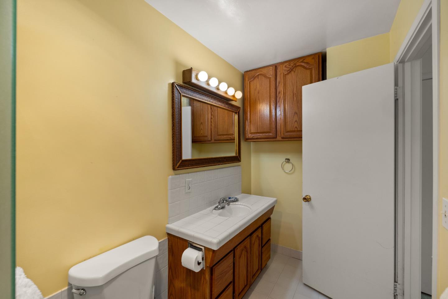 748 Alice Street Monterey, CA 93940 - Photo 24 of 36 a bathroom with a toilet sink and mirror