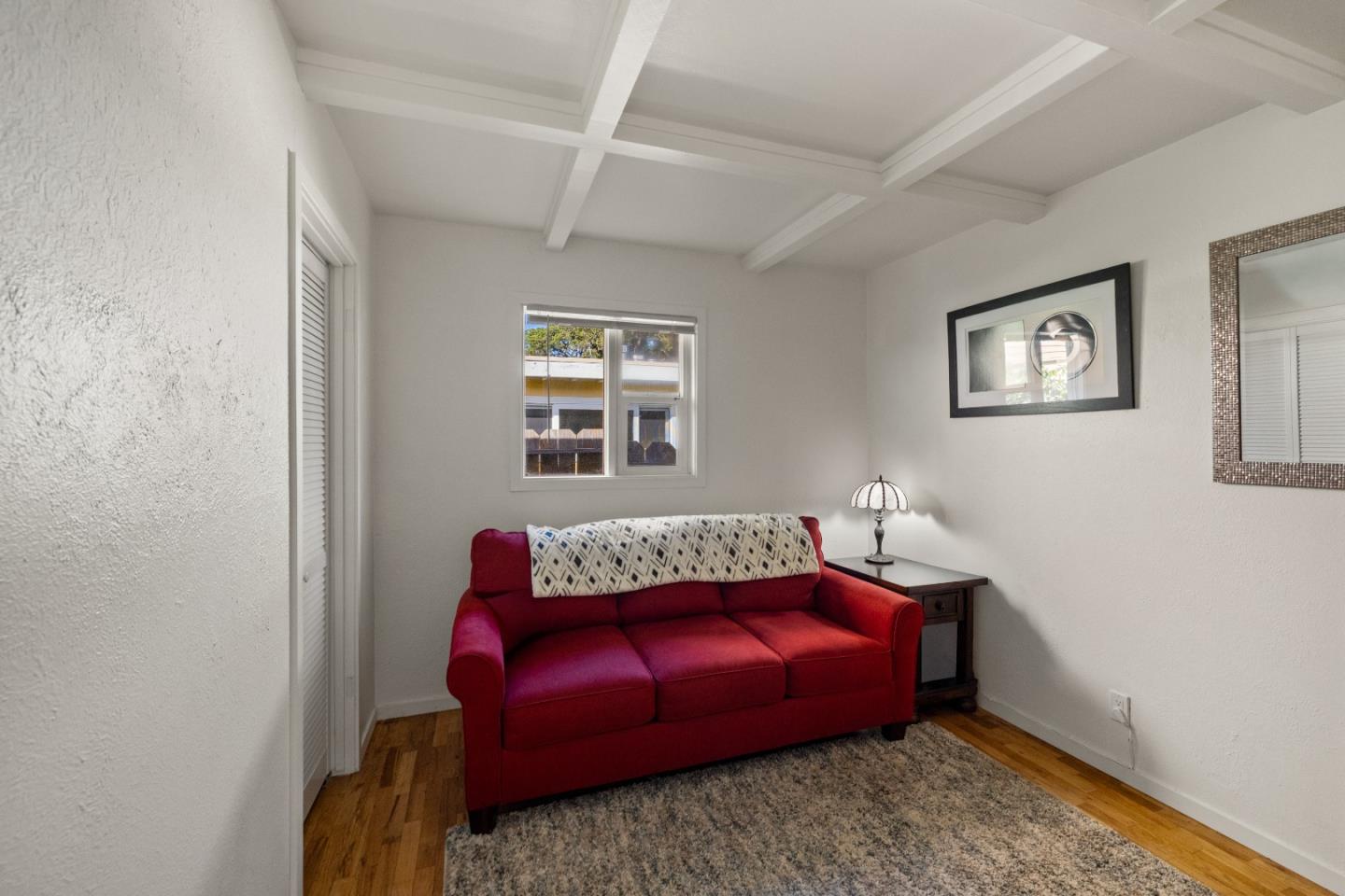 748 Alice Street Monterey, CA 93940 - Photo 25 of 36 a bedroom with a bed and wooden floor
