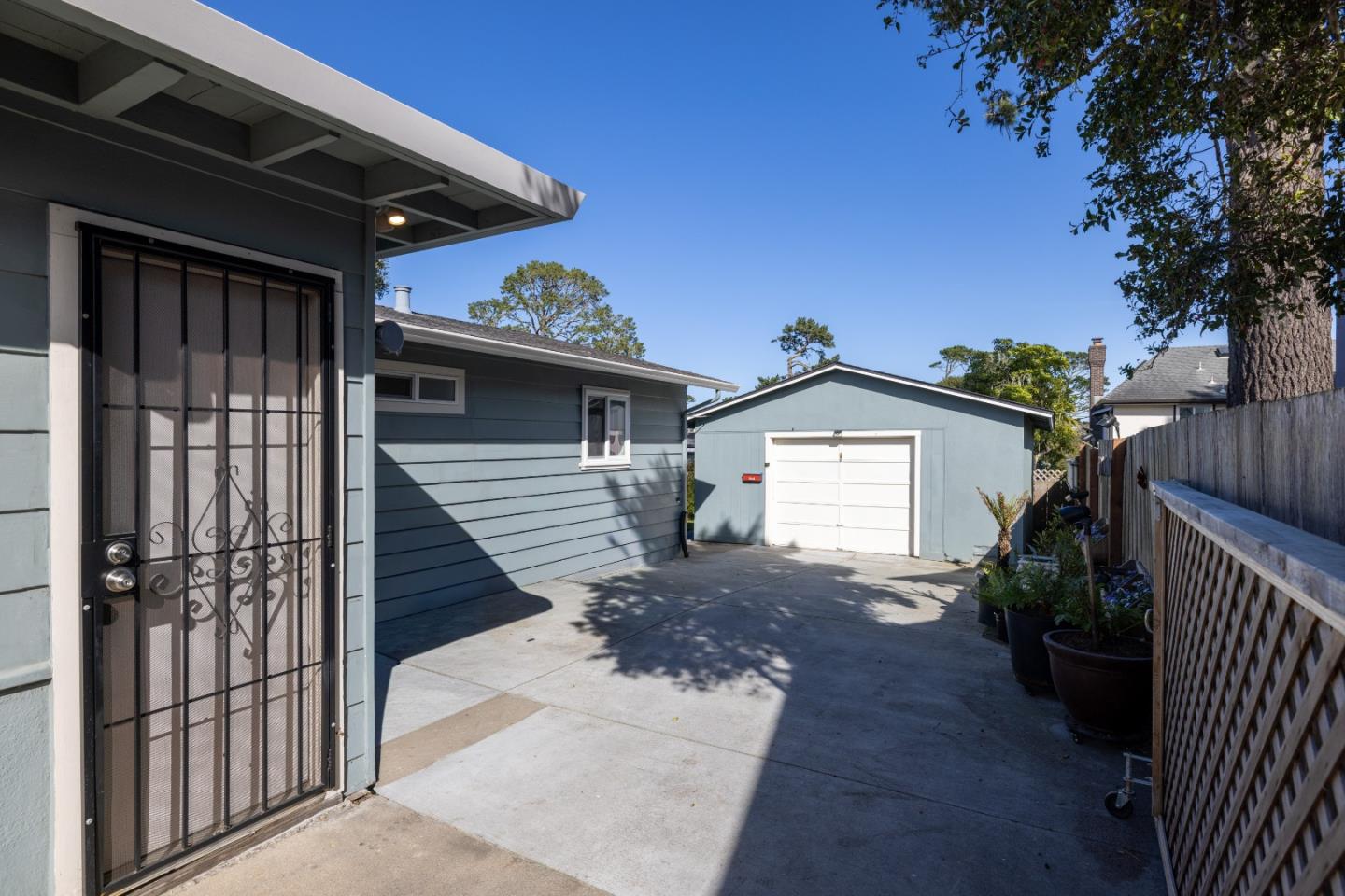 748 Alice Street Monterey, CA 93940 - Photo 28 of 36 a view of a house with a small yard and wooden fence