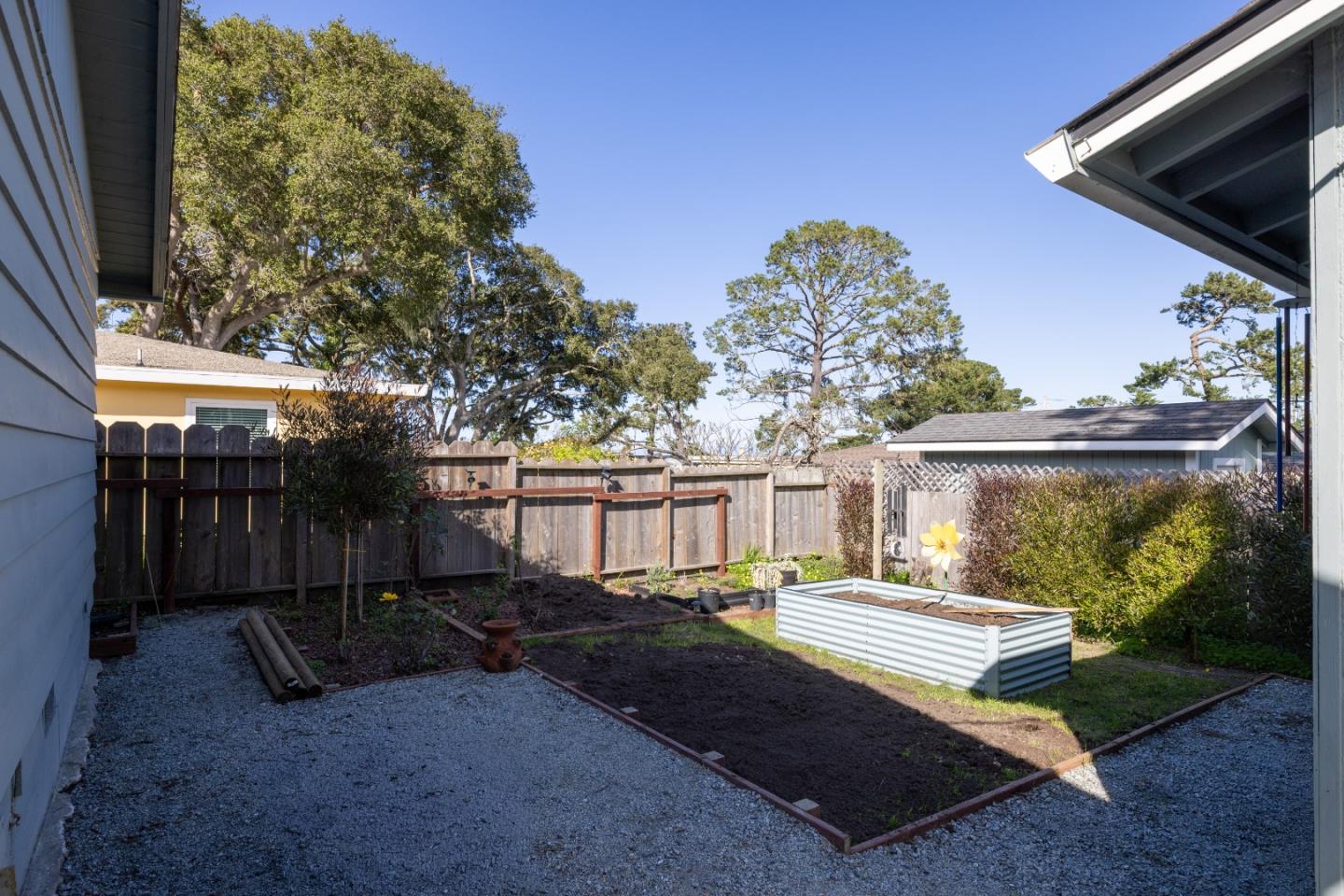 748 Alice Street Monterey, CA 93940 - Photo 30 of 36 a view of a backyard with large trees and wooden fence