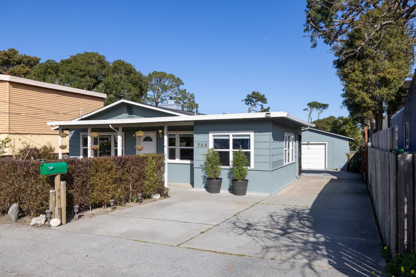 748 Alice Street Monterey, CA 93940 - Photo 36 of 36 a front view of a house with a yard and potted plants