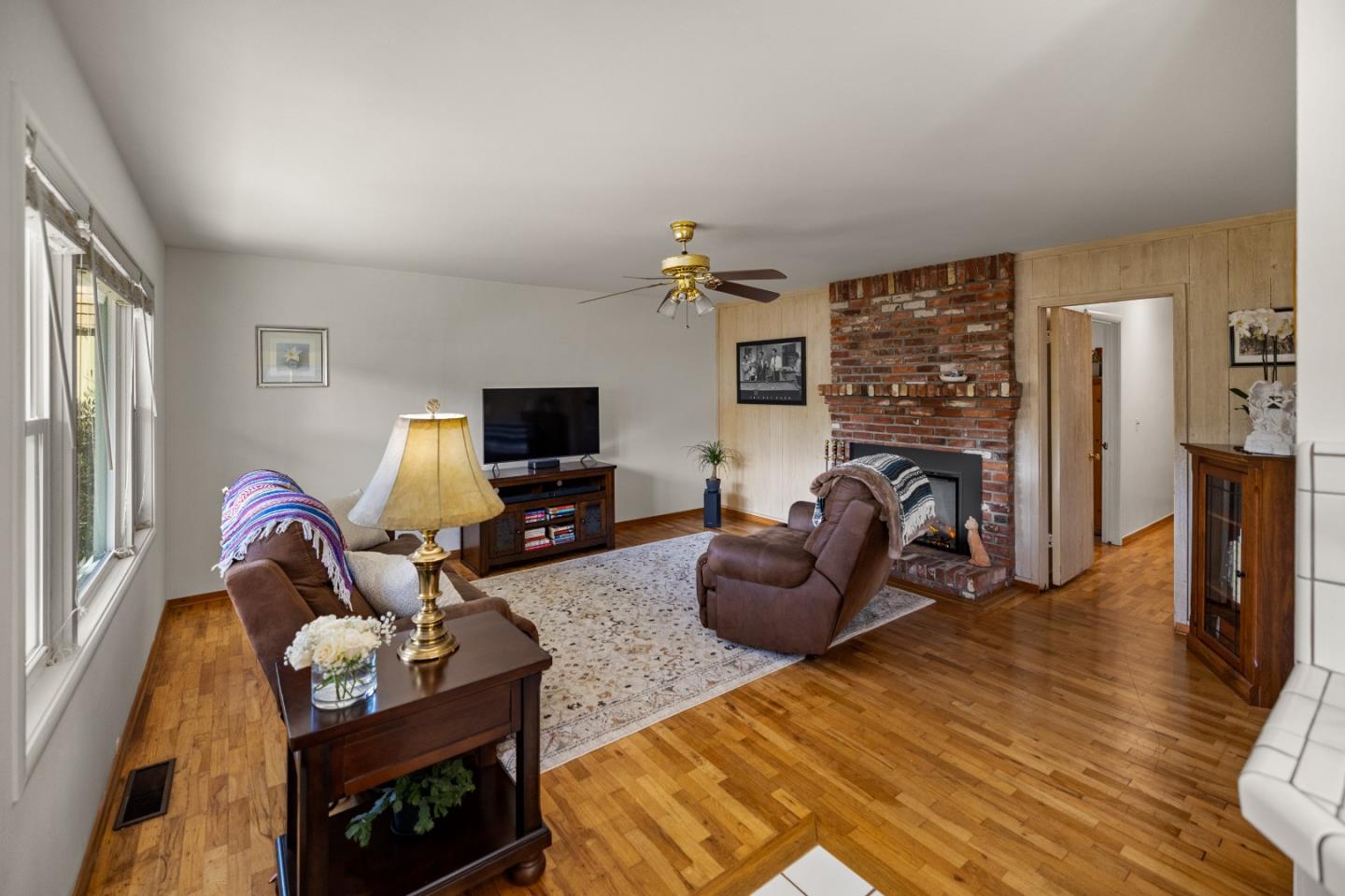 748 Alice Street Monterey, CA 93940 - Photo 7 of 36 a living room with furniture a flat screen tv and a fireplace