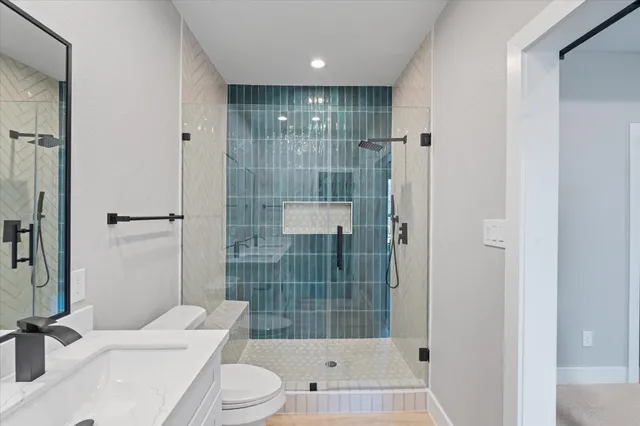 a bathroom with a sink toilet and shower