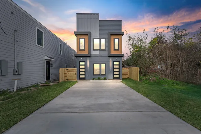 a front view of a house with a yard and a yard