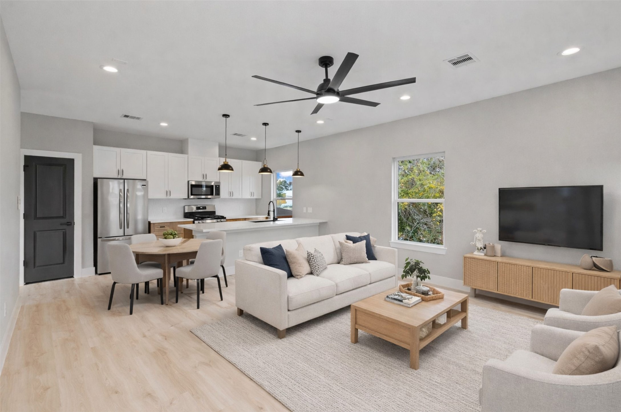 7349 Sandle Street, Unit B Houston, TX 77088 - Photo 2 of 19 a living room with furniture and a flat screen tv with kitchen view